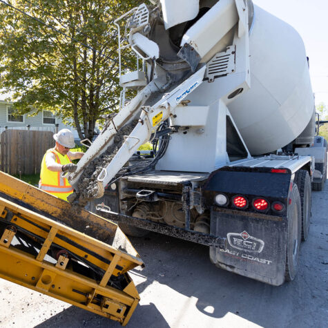 A worker of United Concrete & Asphalt working on a road.